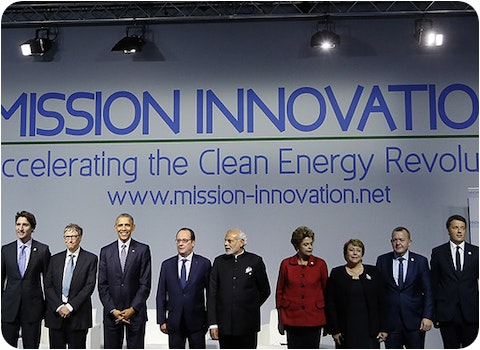 world leaders standing on stage in front of mission innovation banner