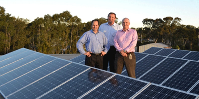 3 men from macquarie bank standing next to rooftop solar installation