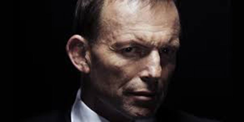 tony abbott's face looking ominous against black background