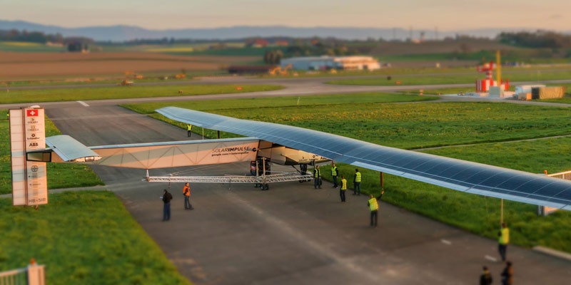 Solar Impulse 2 single-seater solar plane on runway getting checked by aviation officials
