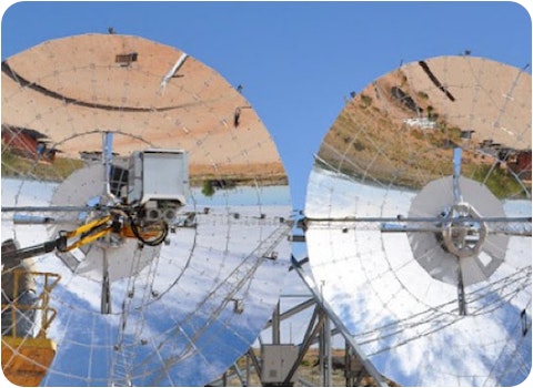 two 12m diameter mirrored ripasso solar energy dishes with blue sky background