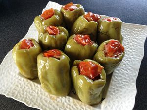 green peppers stuffed with rice topped with tomato skin