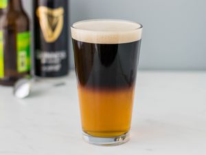 Black and tan beer in a pint glass