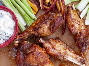 Deep fried turkey wings with buffalo style spicy sauce, blue cheese dressing and crudités