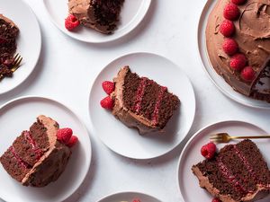Chocolate Raspberry Layer Cake on a platter and cake slices on plates
