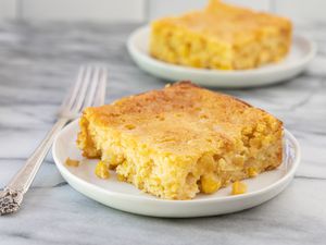 plates with cornbread casserole and fork