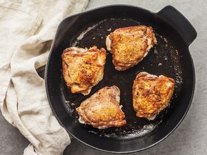 Turn chicken wings over and continue cooking in skillet