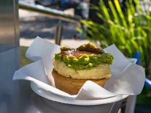 Australian individual meat pie with mashed potato topping, mushy peas, and gravy