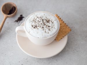 Cafe Latte in a coffee cup with a cookie