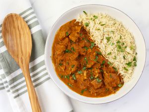 Instant Pot butter chicken in a dish with rice.