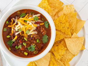instant pot chili in a bowl with tortilla chips on the side
