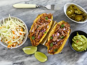 Root beer pulled pork in tacos with slaw and peppers.