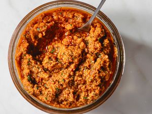 Sun-Dried Tomato Pesto in a glass bowl with a spoon 
