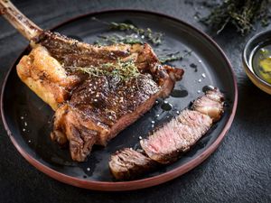 Tomahawk rib-eye steak on a plate