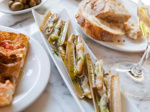 Baby razor clams, tomato rubbed on bread, bread; olives; white wine