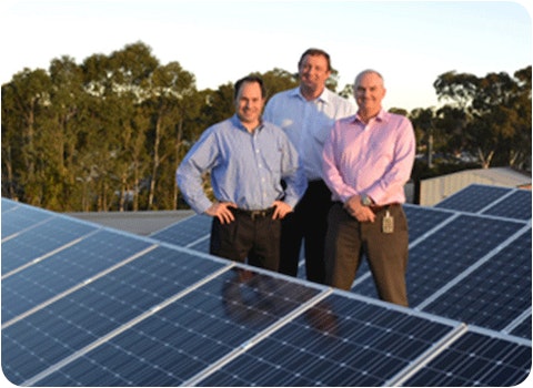 3 men from macquarie bank standing next to rooftop solar installation