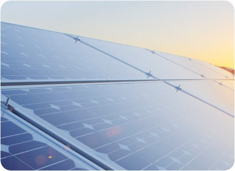 9 solar panels on tile roof at sunset