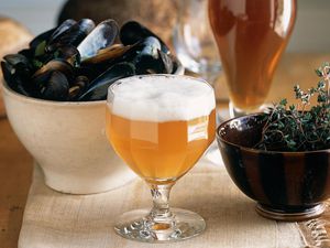 Two Glasses of Lambic Beer With a Bowl of Steamed Mussels and Thyme