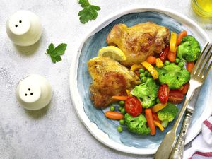 Grilled chicken thigh garnished with vegetables